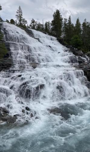 a waterfall on the side of a river at Three bedroom holiday house with jacuzzi in Bjorli , pets allowed in Bjorli
