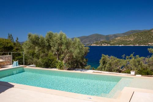 a swimming pool with a view of the water at Villa Mironi - Private sea access in Marantochori