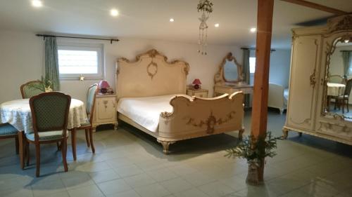 a bedroom with a bed and a table and chairs at Ubytovani Sarka in Čistá