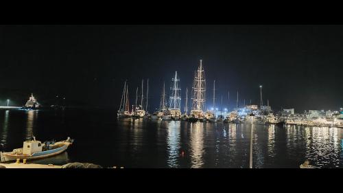 a harbor with boats in the water at night at Marina's Rooms in Lipsoi