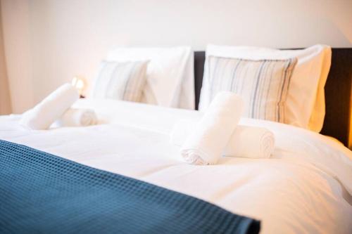 a bed with white sheets and towels on it at Magnificent Two Bedroom Apartment - SD23M in Eindhoven