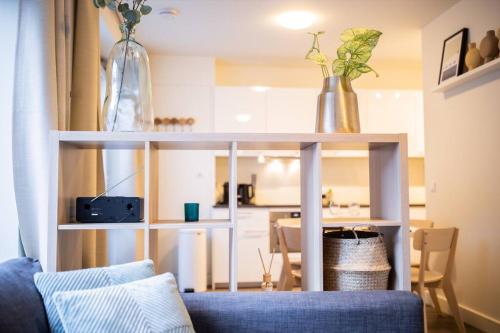 a living room with a couch and a table with vases on it at Magnificent Two Bedroom Apartment - SD23M in Eindhoven