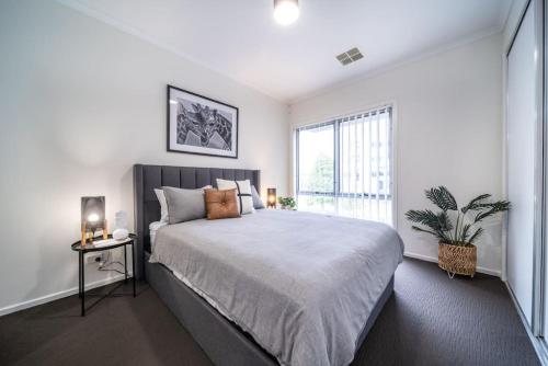 a bedroom with a large bed and a window at Black Oak at Brompton in Bowden