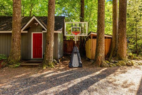 a basketball hoop in front of a house with trees at John Lake Lodge in Rhododendron