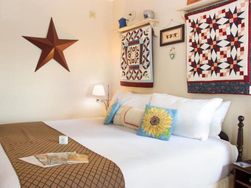 a bedroom with a bed with pillows and stars on the wall at EJ Bowman House Bed & Breakfast in Lancaster