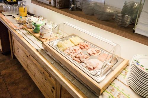 a counter with a tray of meat and cheese at Landgasthof Sepplwirt in Kindberg