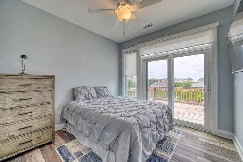 a bedroom with a bed and a dresser and a window at Into The Mystic in Surf City