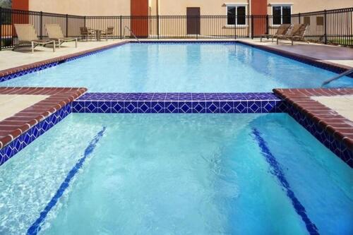 a large pool with blue water in a hotel at Four Points by Sheraton Houston Hobby Airport in Houston