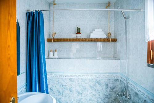 a bathroom with a shower and a tub and a sink at Casa da Ernesta in Mondim de Basto