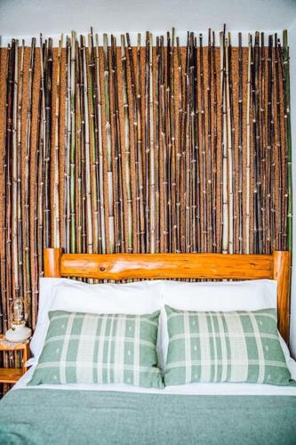 a bedroom with a bed with a bamboo wall at Casa da Ernesta in Mondim de Basto