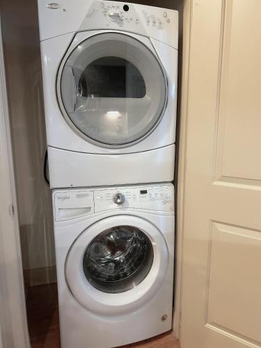 a washing machine and a dryer in a room at Domain at Kirby in Houston