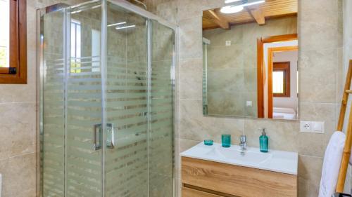 a bathroom with a glass shower and a sink at La Pasadilla Alozaina by Ruralidays in Alozaina