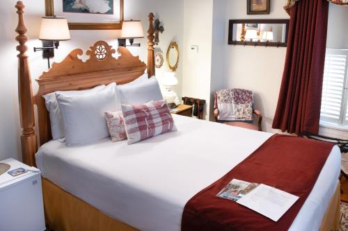 een hotelkamer met een groot bed en een stoel bij EJ Bowman House Bed & Breakfast in Lancaster