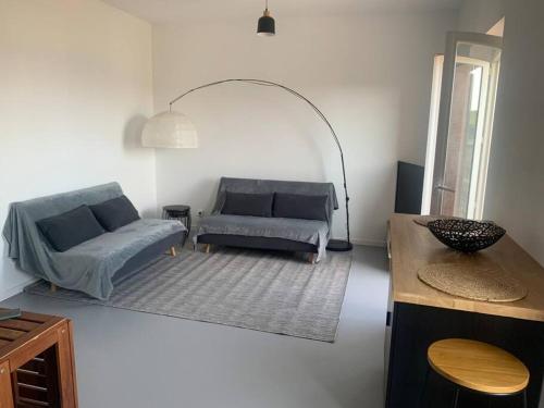 a living room with two couches and a table at T3 vue mer in Le Lavandou