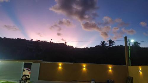 a sunset over a building with lights on at Casa de Praia Pontal in Ilhéus