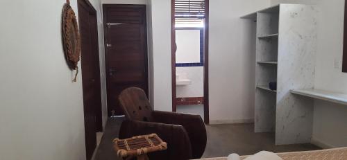 a living room with a chair and a window at Casa Grande in Galinhos