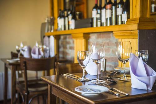 a table with wine glasses and plates on it at Hosteria Senderos in El Chalten