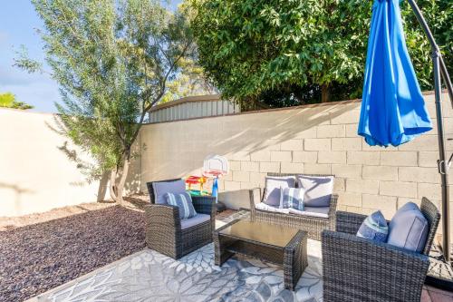 a patio with chairs and a table and an umbrella at Four-Bedroom Holiday Home in Tucson