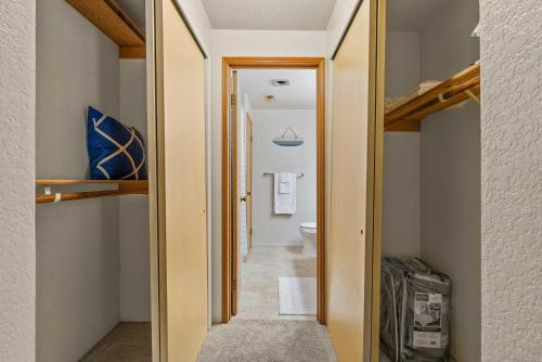 a hallway with a door leading to a bathroom at Cozy Tacoma Home with Patio, Walk to Beach! in Tacoma