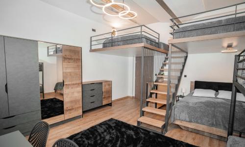 a bedroom with a bunk bed and a staircase at Apartmánový dům Sklípek in Trutnov