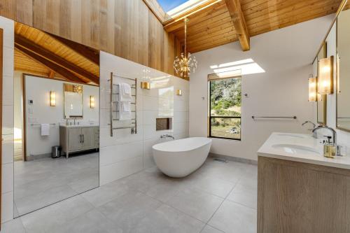 a large bathroom with a tub and a sink at Breakers Retreat in Sea Ranch