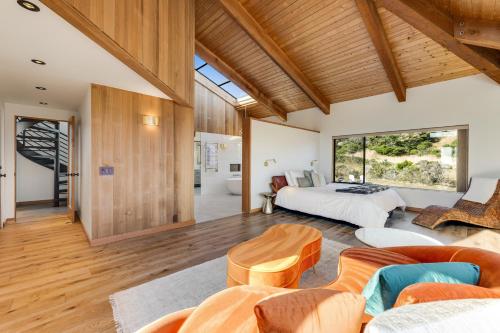 a bedroom with a bed and a living room at Breakers Retreat in Sea Ranch