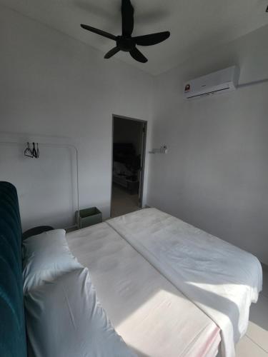 a bedroom with a bed with a ceiling fan at Horizon Premium Suite - Ipoh in Ipoh