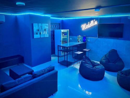 a blue room with a couch and a table at Luxury Villa In Provenza in Medellín