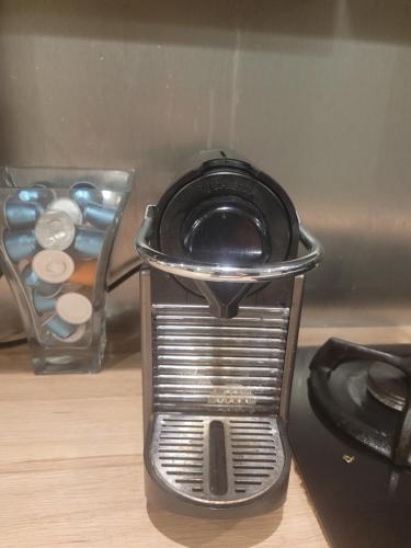 a toaster sitting on a counter next to a stove at Logement de Ville 4 chambres proche de Lille in Tourcoing
