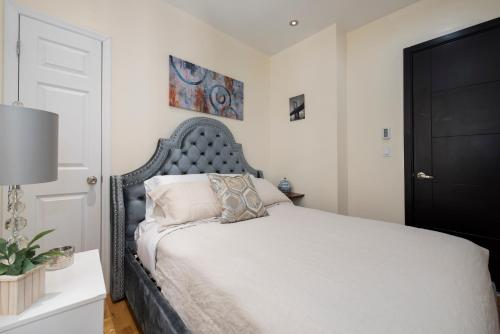 a bedroom with a bed with a black headboard at 3BR in Amsterdam Ave! in New York