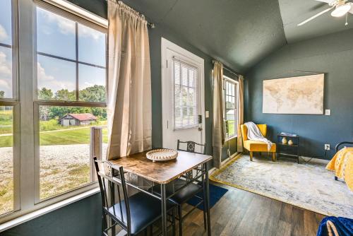 a room with a table and chairs and windows at Brownsville Studio Cottage - Walk to Mammoth Cave! in Brownsville