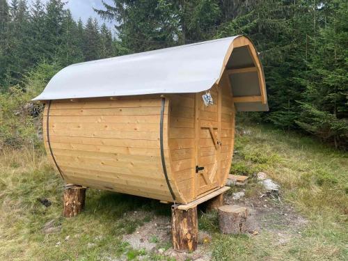 a small wooden boat sitting on logs in a field at GAGO’S WOODEN HOUSE in Plav
