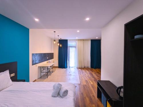 a bedroom with a bed and a desk in a room at Milky Way in Stepantsminda