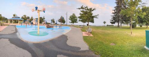 a park with a playground with a slide at PARADISE VILLa in Bowmanville