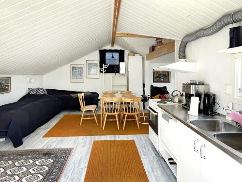 a kitchen and living room with a couch and a table at 4 person holiday home in ALVESTA-By Traum in Alvesta