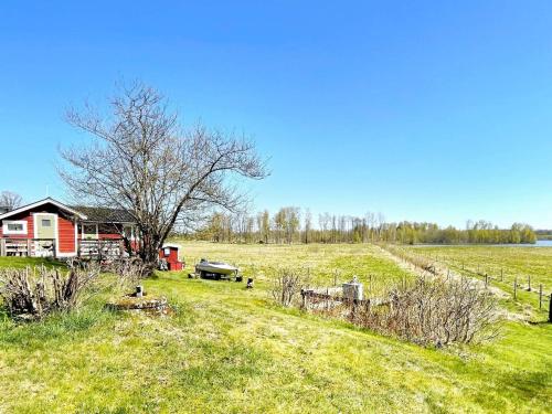 a house in the middle of a grassy field at 4 person holiday home in ALVESTA-By Traum in Alvesta