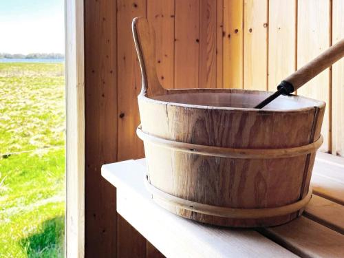 a wooden bucket sitting on a shelf next to a window at 4 person holiday home in ALVESTA-By Traum in Alvesta