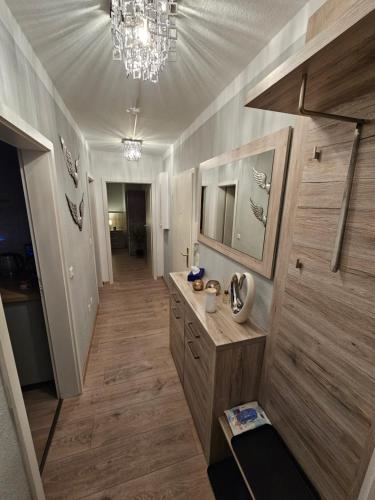 a bathroom with a sink and a chandelier at schlafgut24 in Dortmund