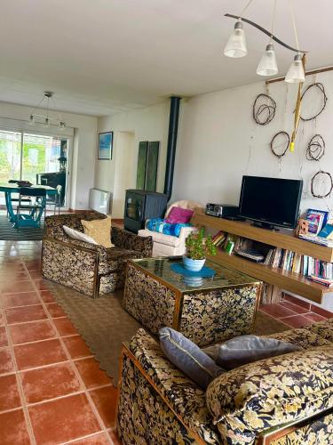 a living room filled with couches and a table at la maison d'hôtes des Charentes in Les Touches-de-Périgny
