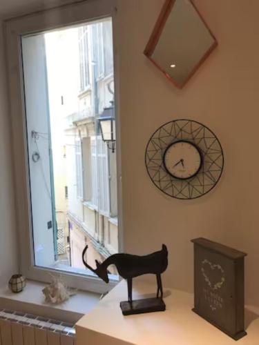 a cat statue sitting on a counter next to a window at Studio à 100m du Palais des Festivals / Plages et Commerces in Cannes