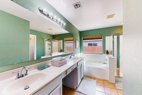 a bathroom with two sinks and a large mirror at Blue Umbrella Retreat in Avondale