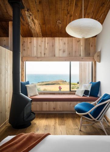 a room with a large window with a couch and a chair at The Sea Ranch Lodge in Sea Ranch