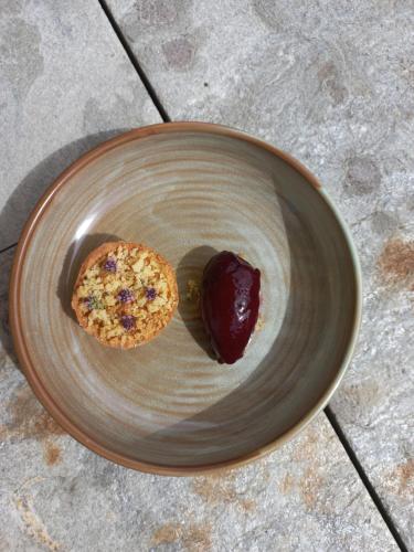 a plate with a cookie and jelly on it at Hotel Pazzola in Disentis