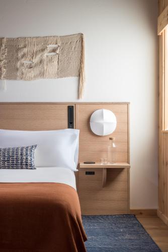 a bedroom with a bed with a wooden headboard and a mirror at The Sea Ranch Lodge in Sea Ranch