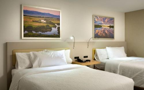 a hotel room with two beds and a table at Hilton Garden Inn Boise Downtown in Boise