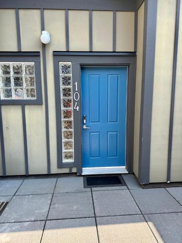 a blue door on the side of a building at Sooke Oceanview Penthouse - Family Friendly in Sooke