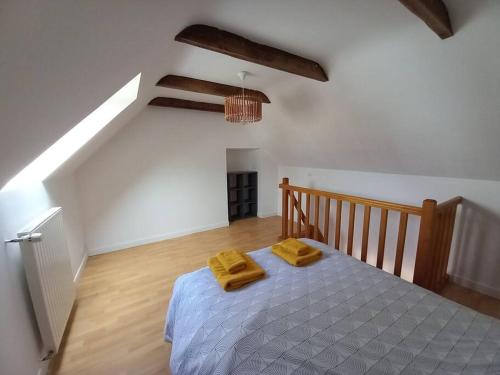 - une chambre avec un lit et 2 serviettes jaunes dans l'établissement Aven, maisonnette avec mezzanine, à Rosporden
