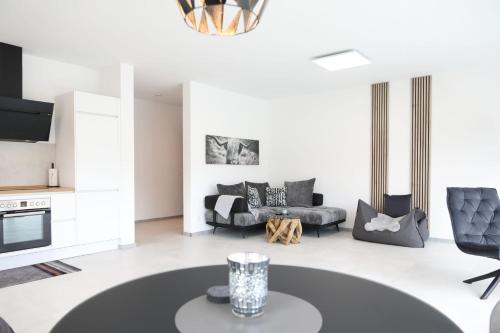 a living room with a couch and a table at MV Römervilla, Lofts & Penthouses mit traumhaftem Moselpanoramablick und Sauna in Treis-Karden