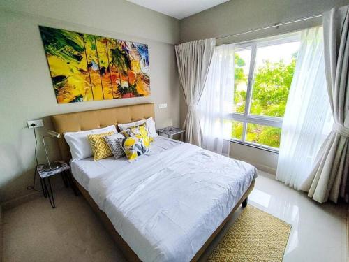 a bedroom with a large bed and a window at Ripples:Pool facing/RiverView/7 mins to Coco Beach in Nerul