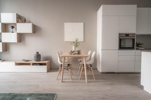 a kitchen with a table and chairs in a room at Arctic Homes - Unique Town House in Tromsø